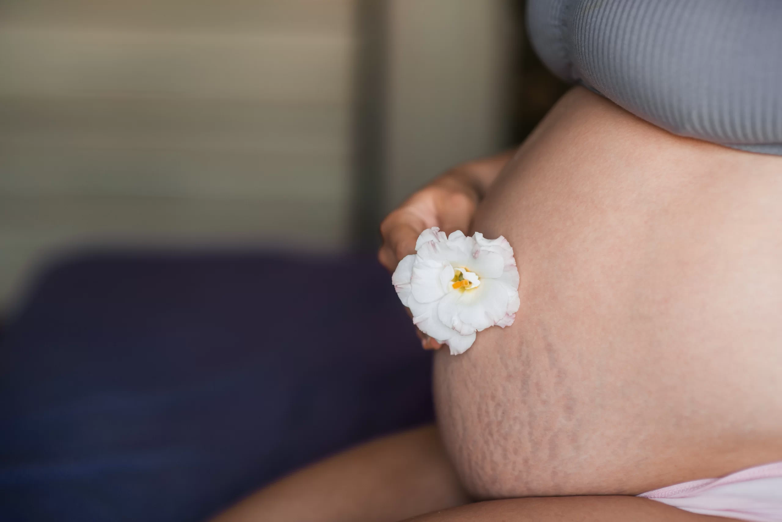 tehotna-zena Těhotná žena držící květinu